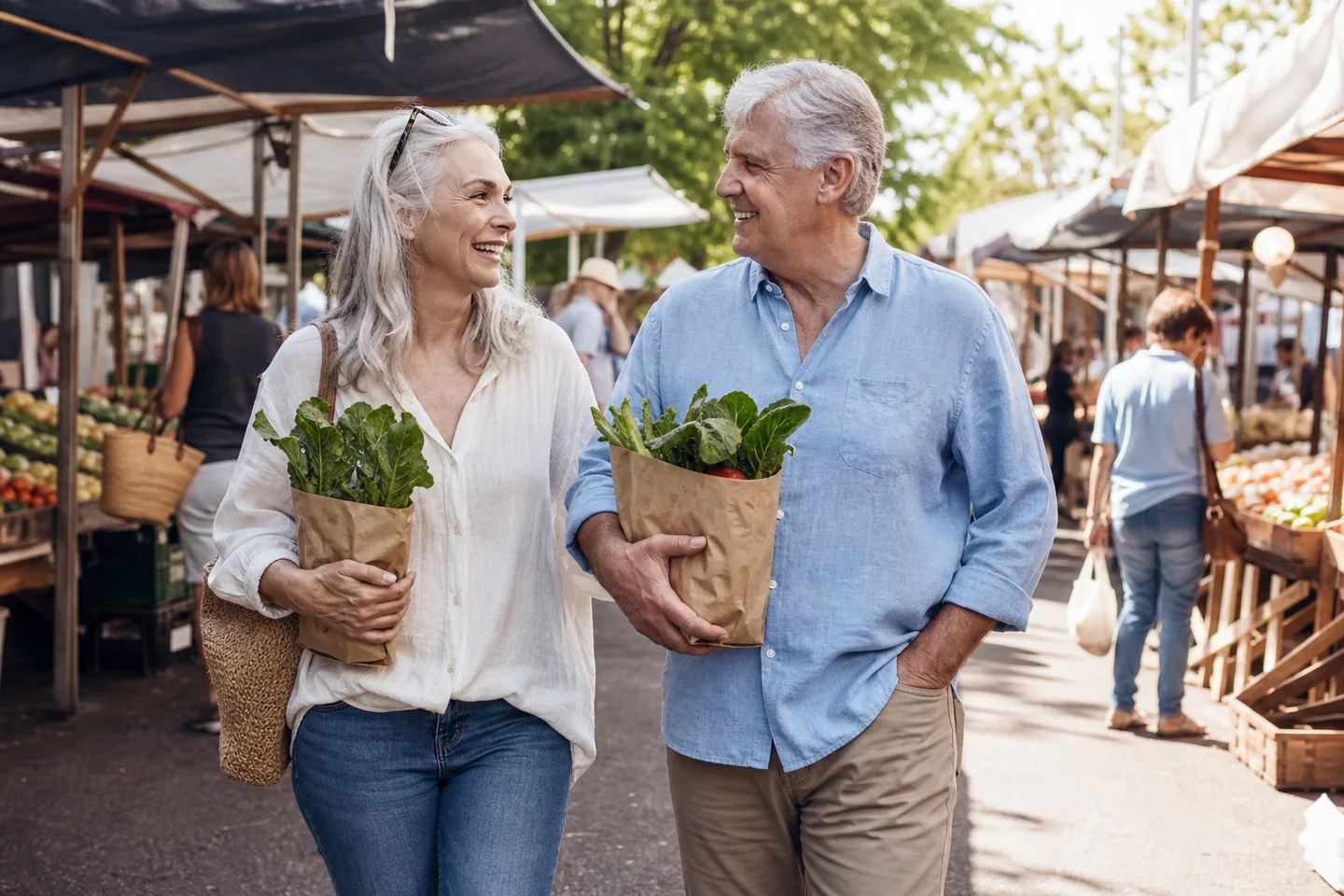 A couple in their sixties smiling together at a weekend market